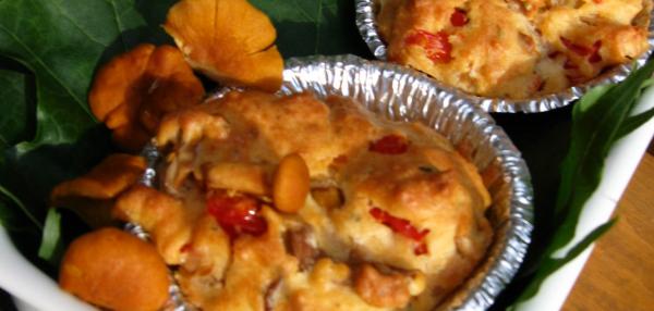 Kaksi pientä muffinia metallivuoassa sekä kantarelleja koristeena